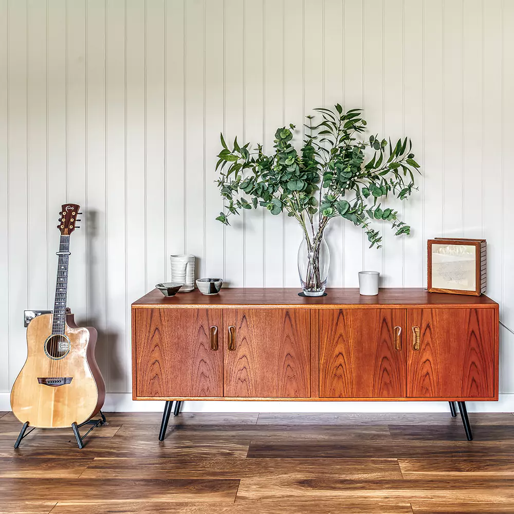 internal view of garden music room with acoustic guitar and retro sideboard