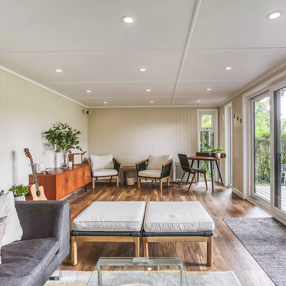 internal view of garden music room with sofas and leather footstool