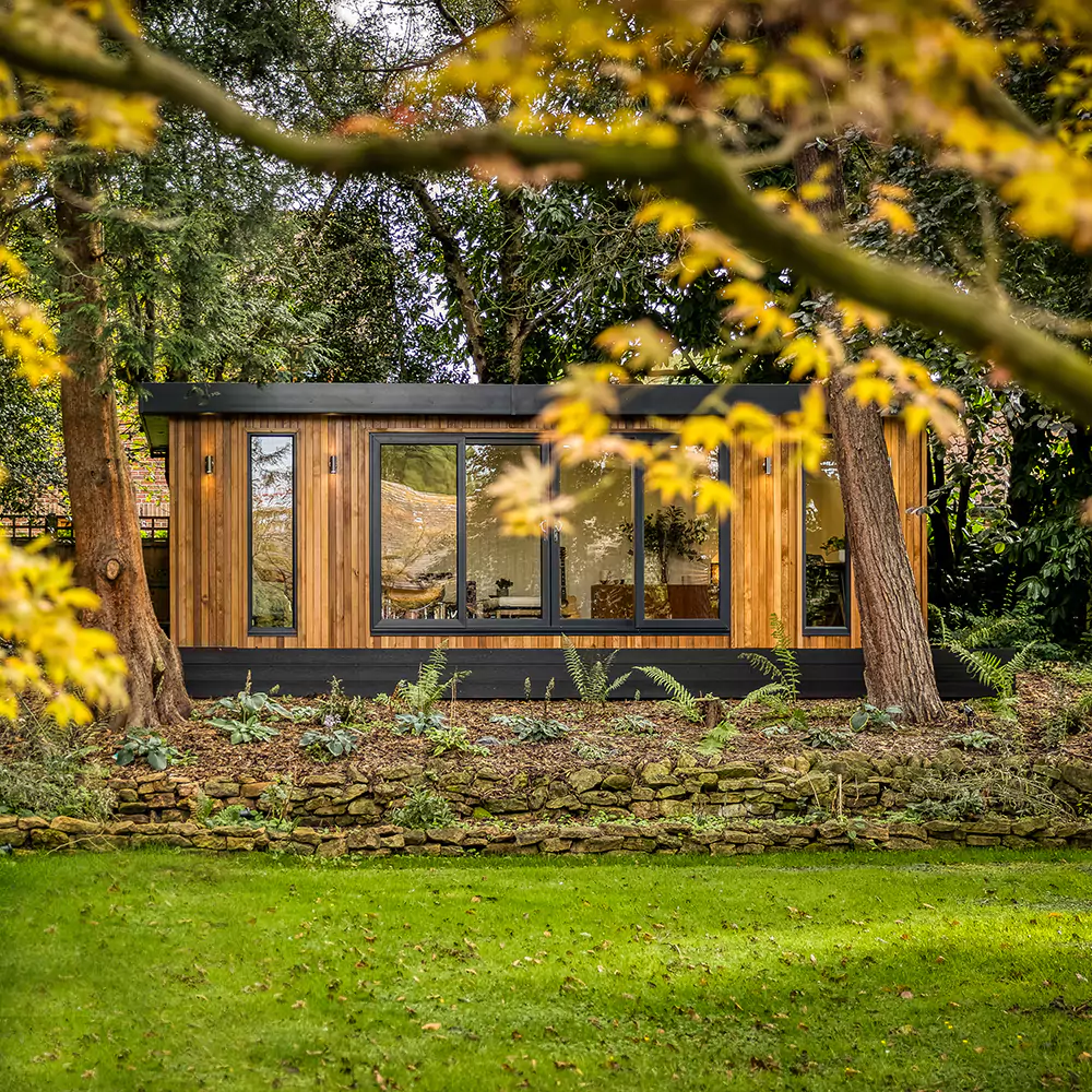 External shot of a large timber garden music studio