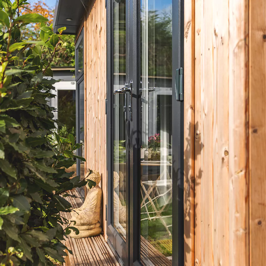 Timber Home Business Room with large glass door and wooden buddha statue