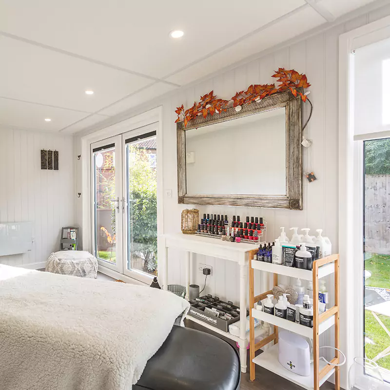 massage bed inside beauty room garden studio with a large mirror and furnishings 