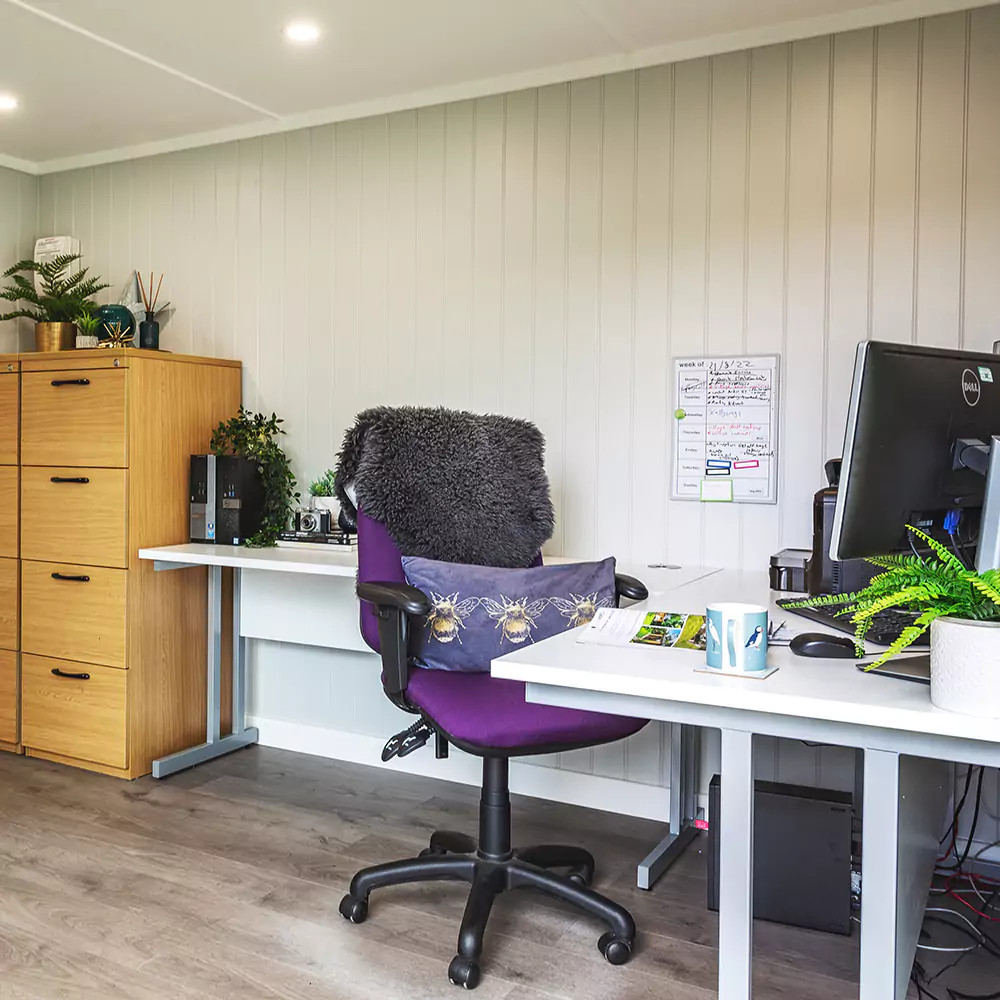 Interior of a small garden office with desk & cabinet