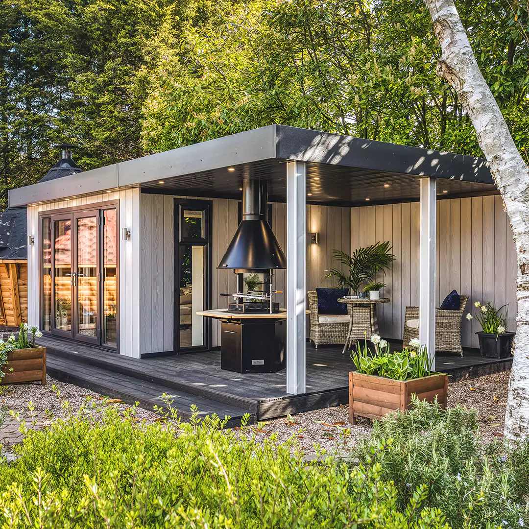 Outside of a zero maintenance garden room bar with patio area and BBQ area