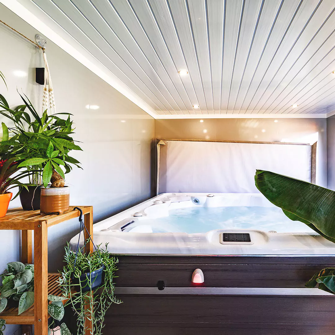 Hydropool Midlands Hot Tub Room internal view with large indoor plants and shower and spotlights in the ceiling