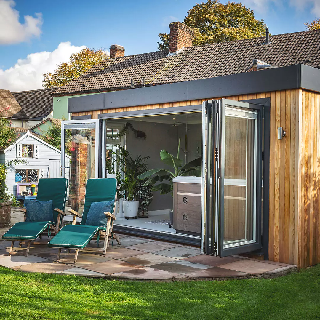 Large garden therapy room with hot tub & bifold doors