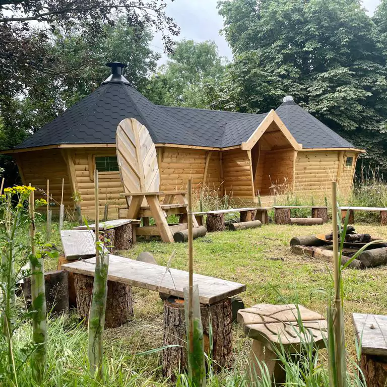 large joined timber cabin at a forest school