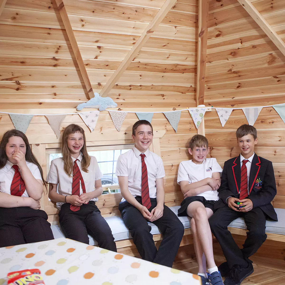 happy school pupils enjoying a lesson inside their cabin classroom