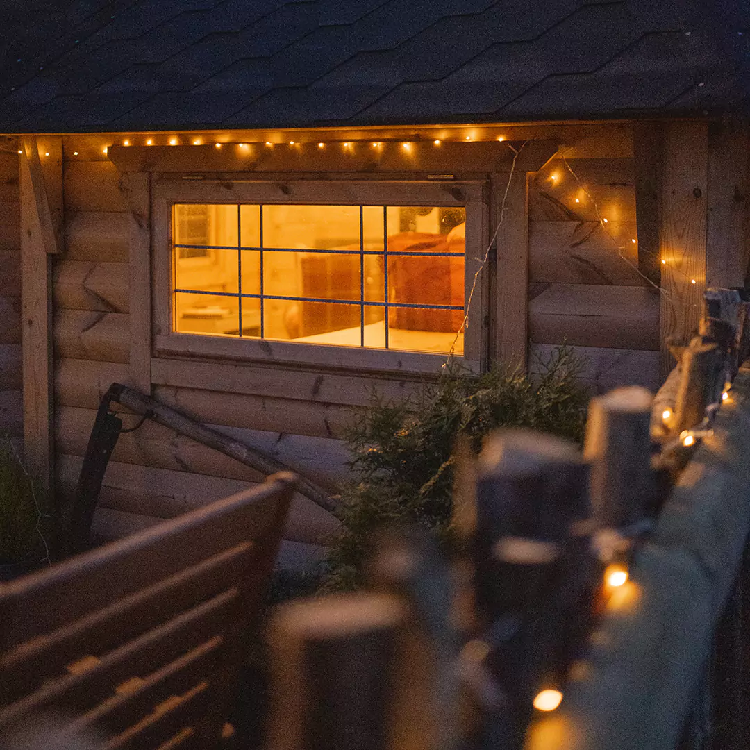 outside close up of windows at night looking into a camping cabin