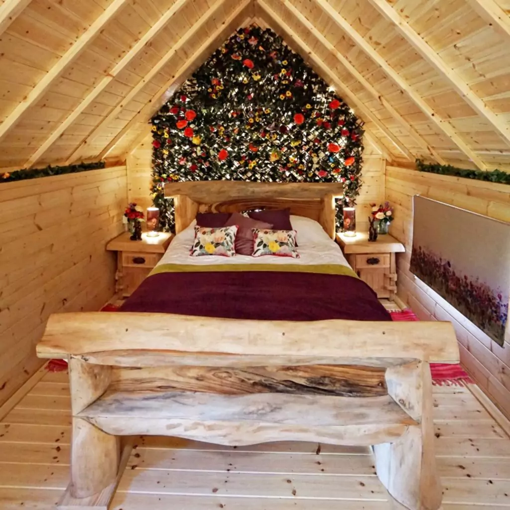 bedroom inside a cosy rustic camping lodge