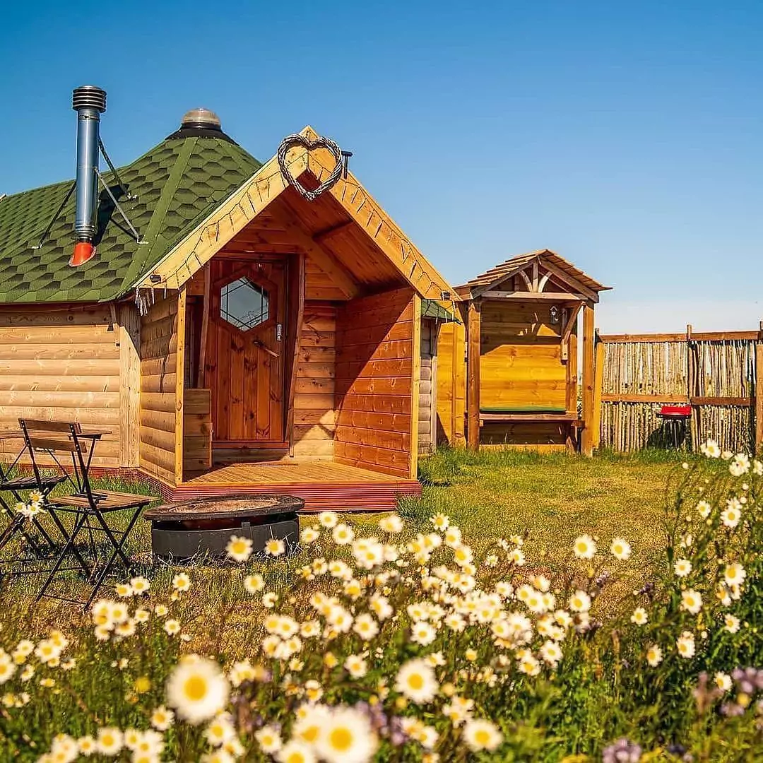 Camping or glamping log cabin in the summer in field at glamping site UK