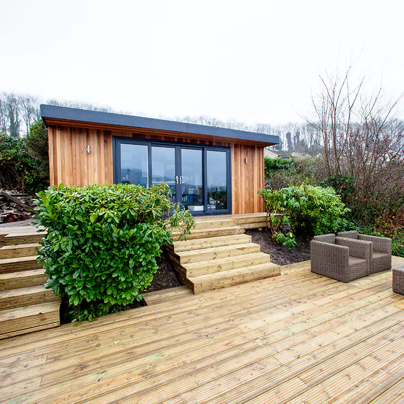 Home Business Garden office on a wooden deck with a couch and chairs on it