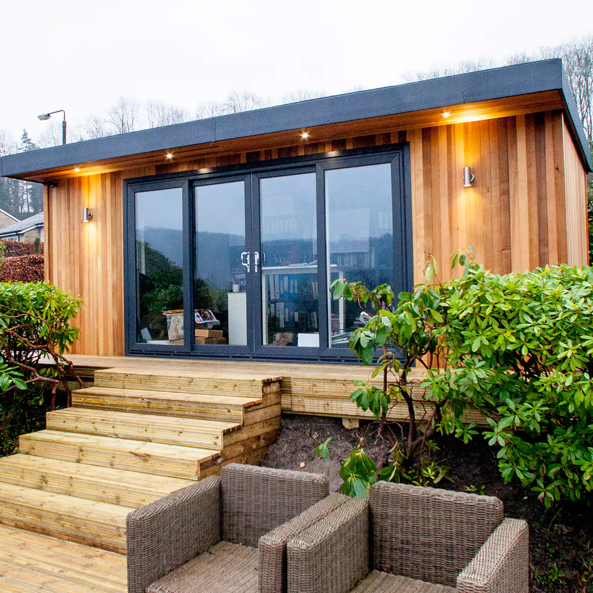 redwood home business office with rattan furniture and timber decking area outside 