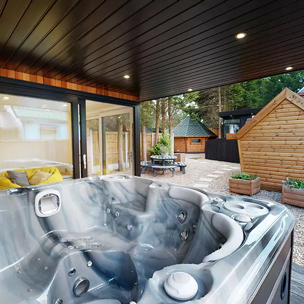 Hydropool midlands hot tub in Show Site Garden Room with Veranda with view of bench and arctic cabins