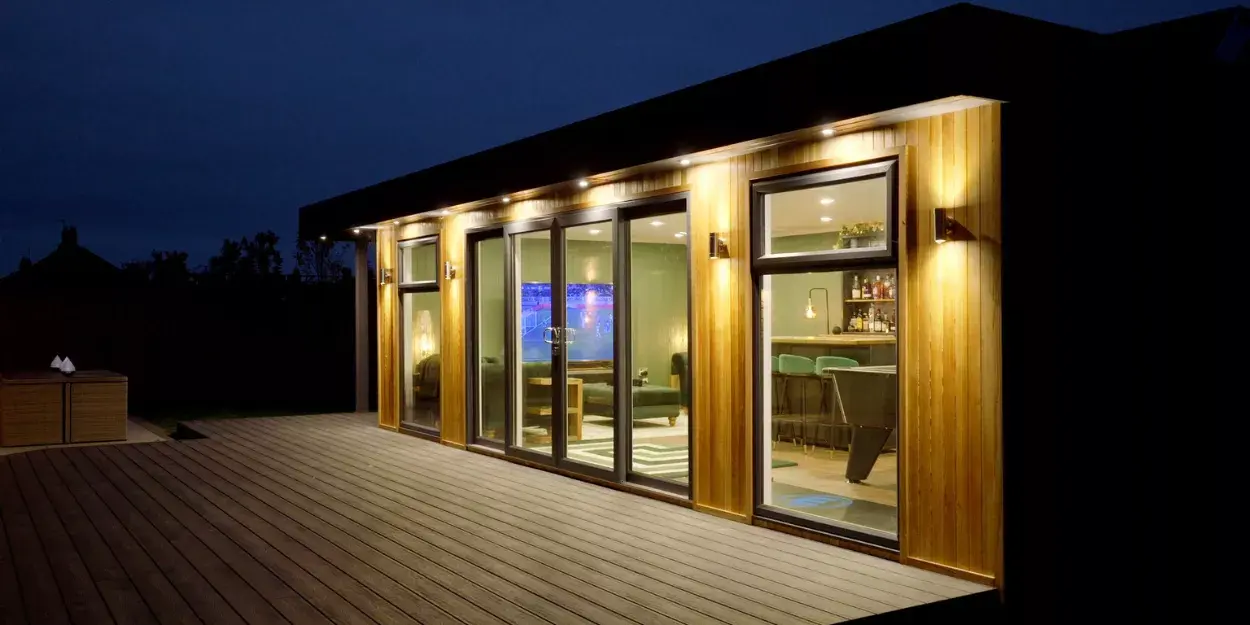 outdoor garden cabin bar lit up at night
