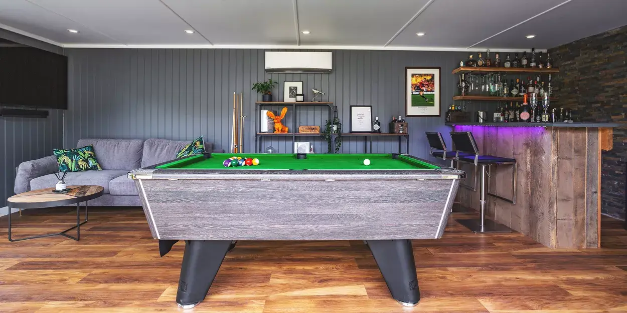 inside a modern garden bar cabin with pool table and LED lights
