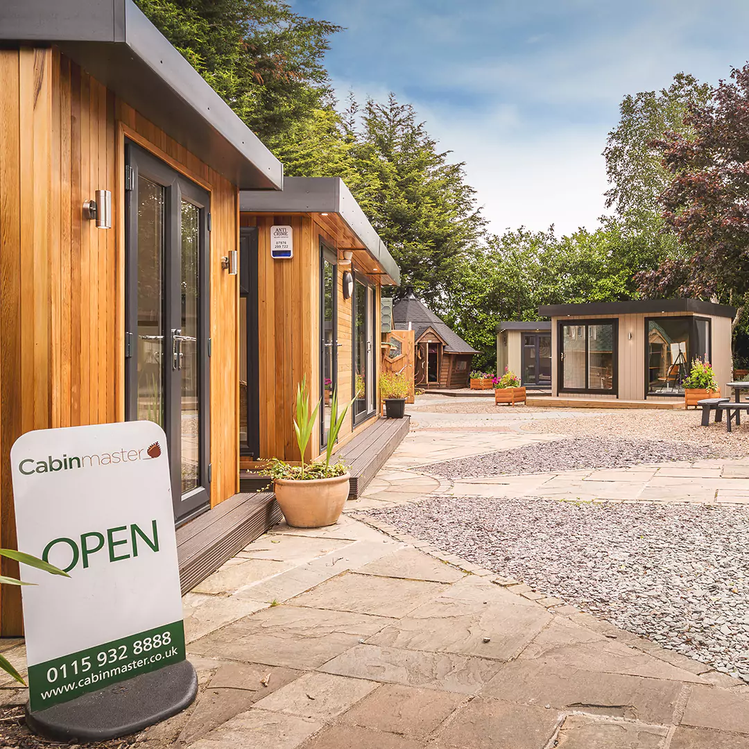 Cabin Master garden rooms show site in Nottingham, looking into the entrance with 'open' sign on the floor near the gate