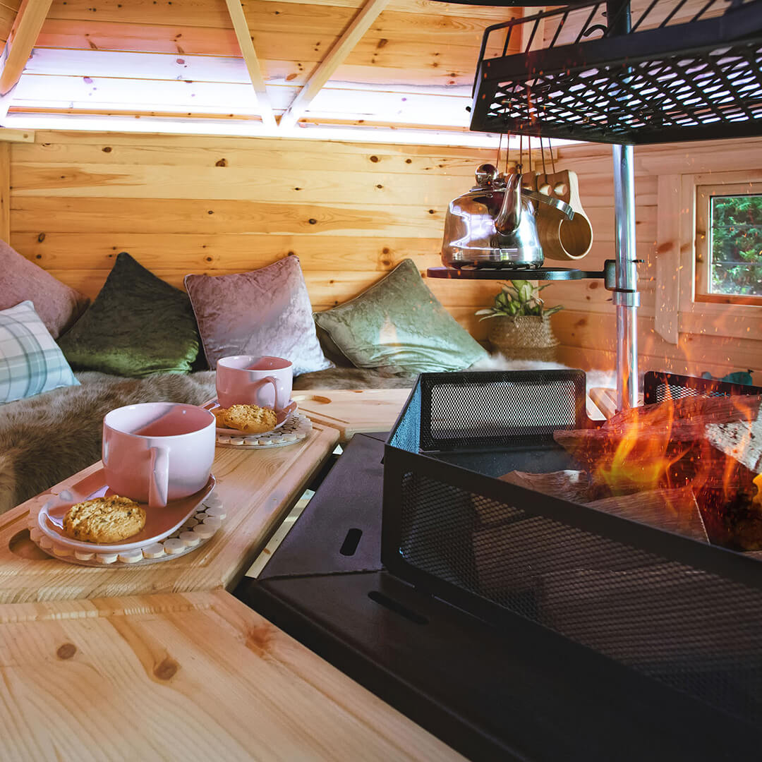 Interior of a Arctic Cabins BBQ Hut with fire lit