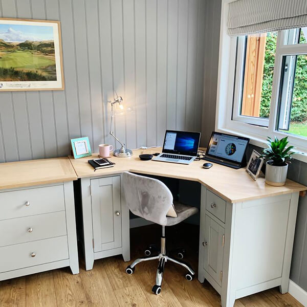 Internal view of Cabin Master Garden Micro Office with marble desk chair and Macbook Laptop and white desk furnishings and wall art