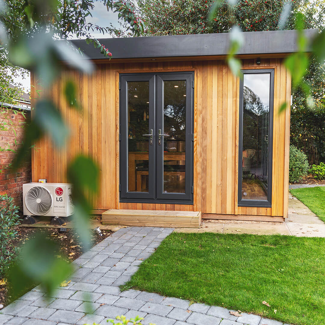 cedar garden building man cave with patio walkway and air conditioning unit on it