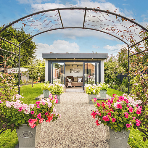 View through a treillis of a modern summerhouse in garden