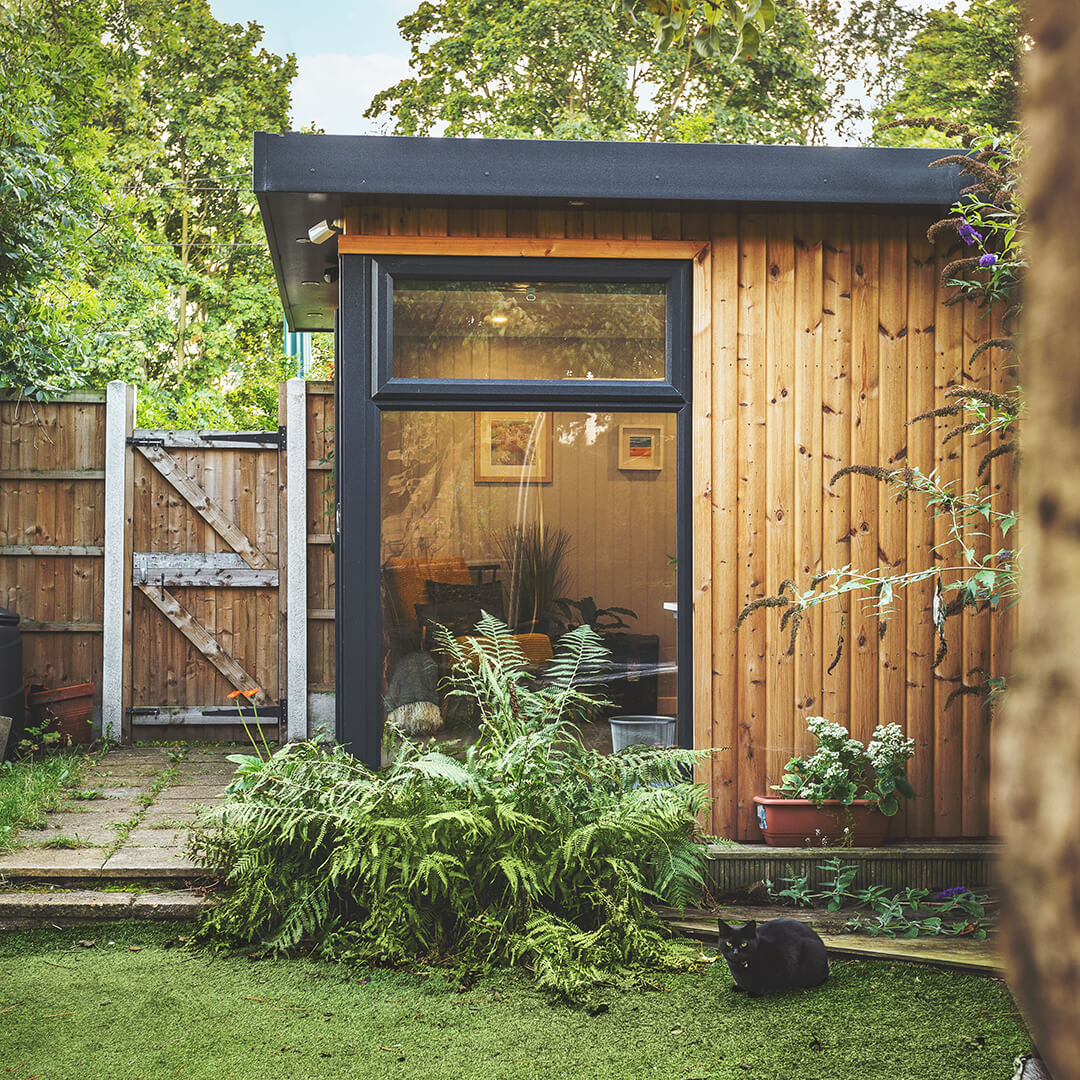 Redwood Garden Office Building with hedge and green lawn area on patio step
