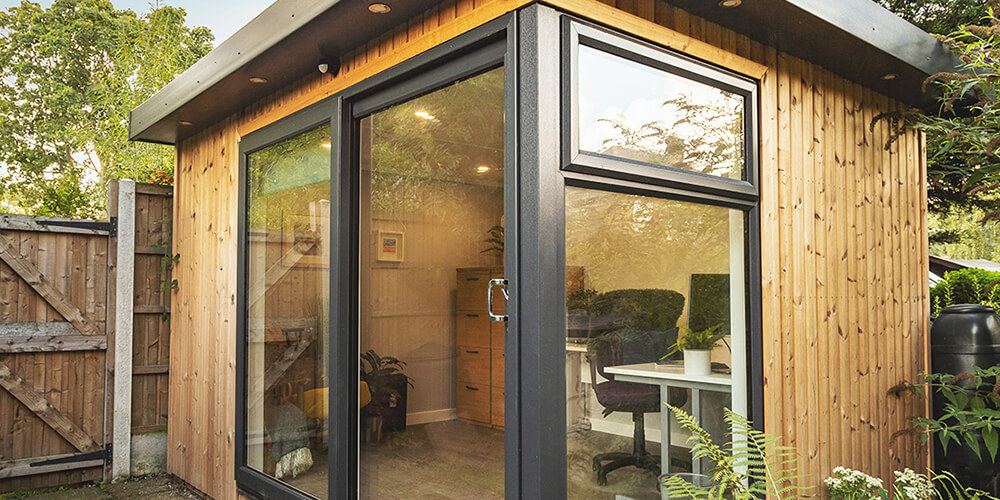 Garden office in corner of small garden