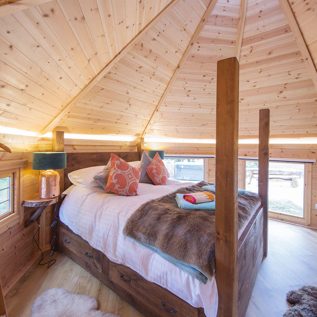 Interior of a luxury timber camping cabin bedroom for guests