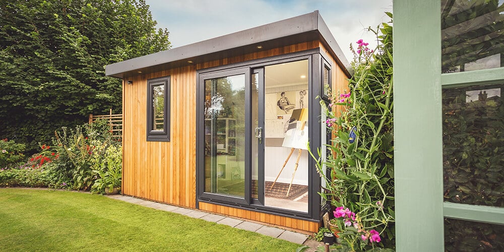 Smaller garden room office with black windows and doors 