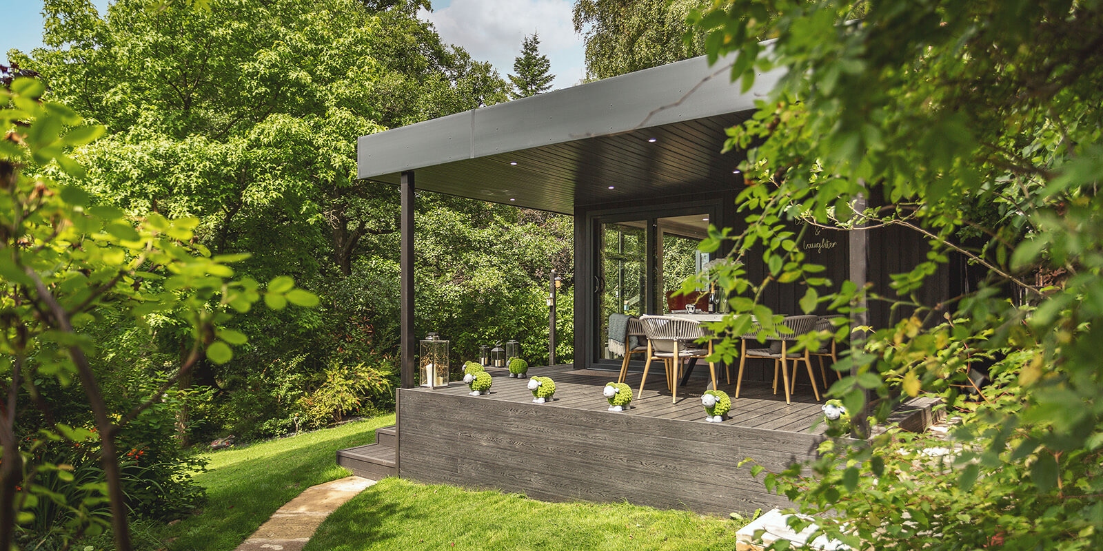 Large zero maintenance garden room with veranda with decking and steps 