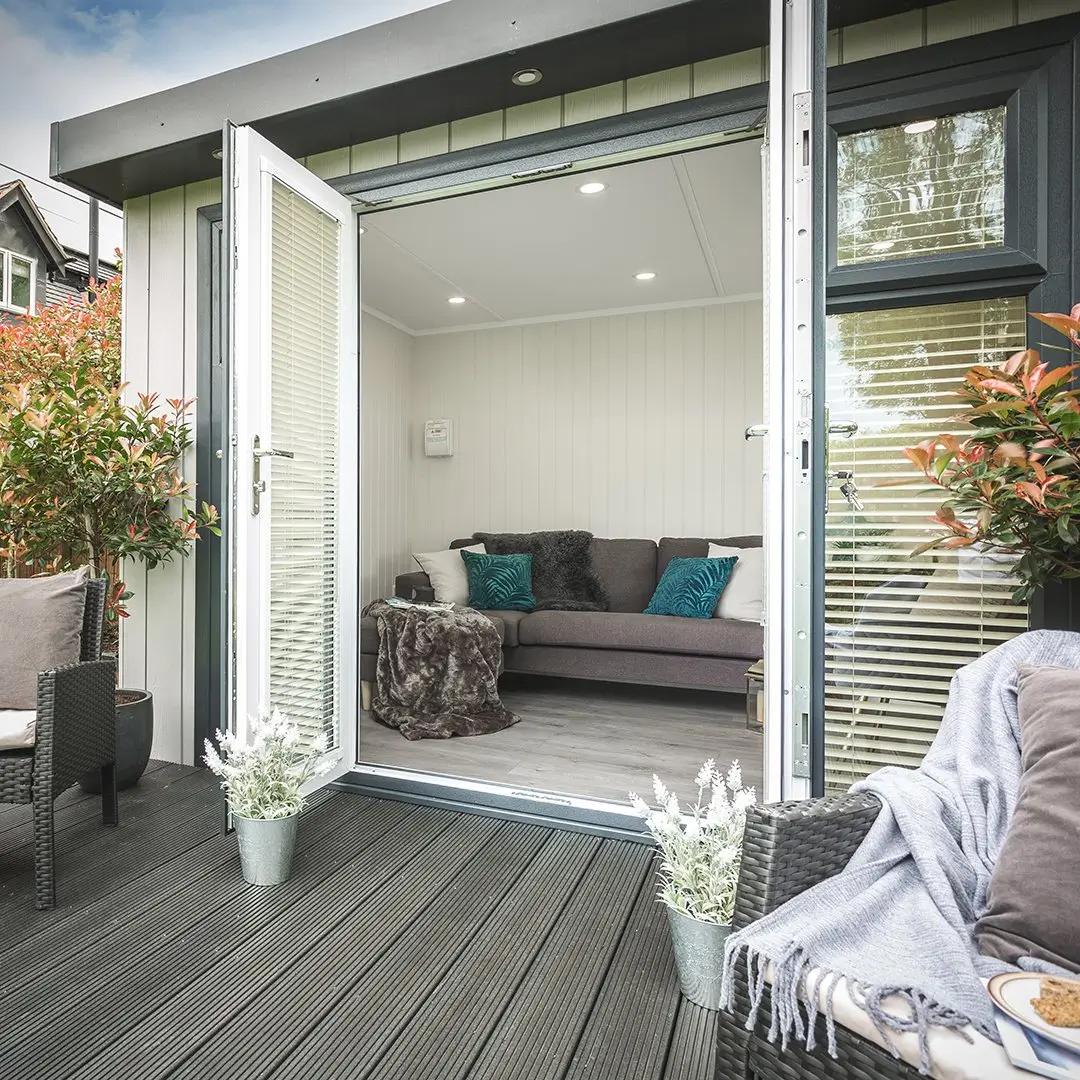 cedral garden room summerhouse with open french doors and large timber decking area 