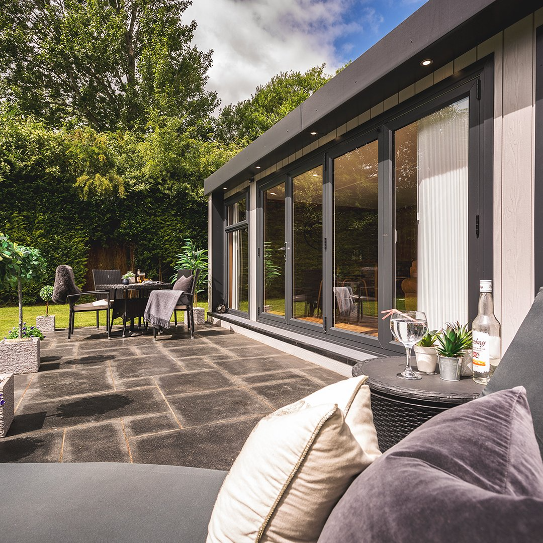 Cedral Garden Bar Building with patio decking and garden furniture in foreground