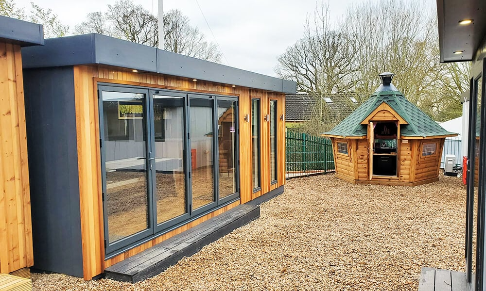 Hybrid clad garden room with cedar front and Arctic BBQ seen at the side
