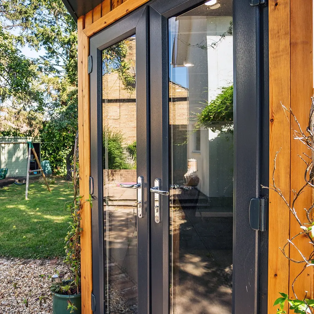 Small Redwood Garden Office with french doors and black fascia 