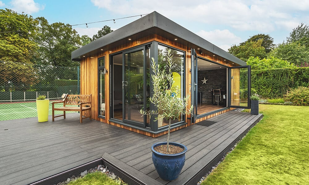 Garden house room with bifolds on decking