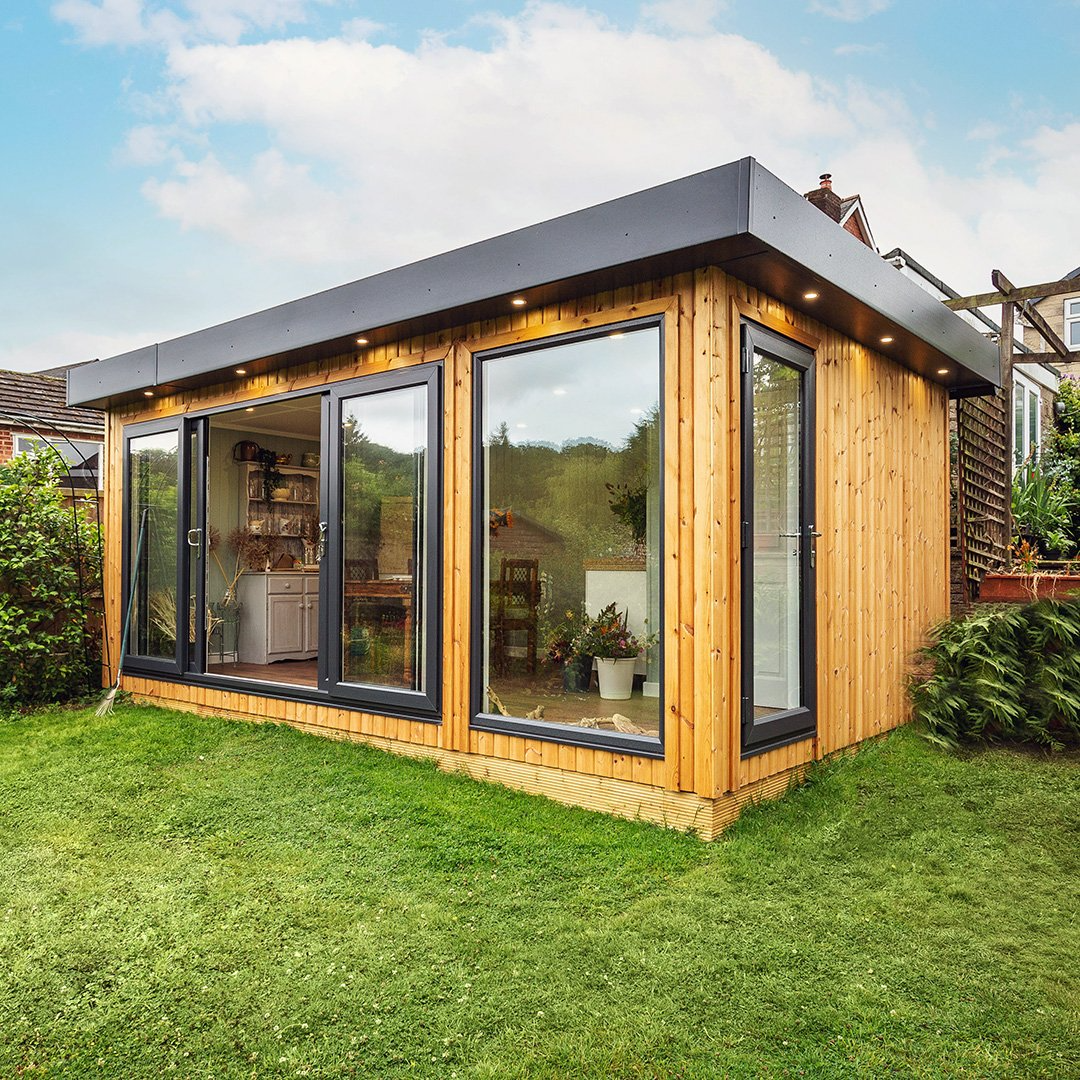 Redwood Garden Room in grassy lawn area with large glass sliding doors