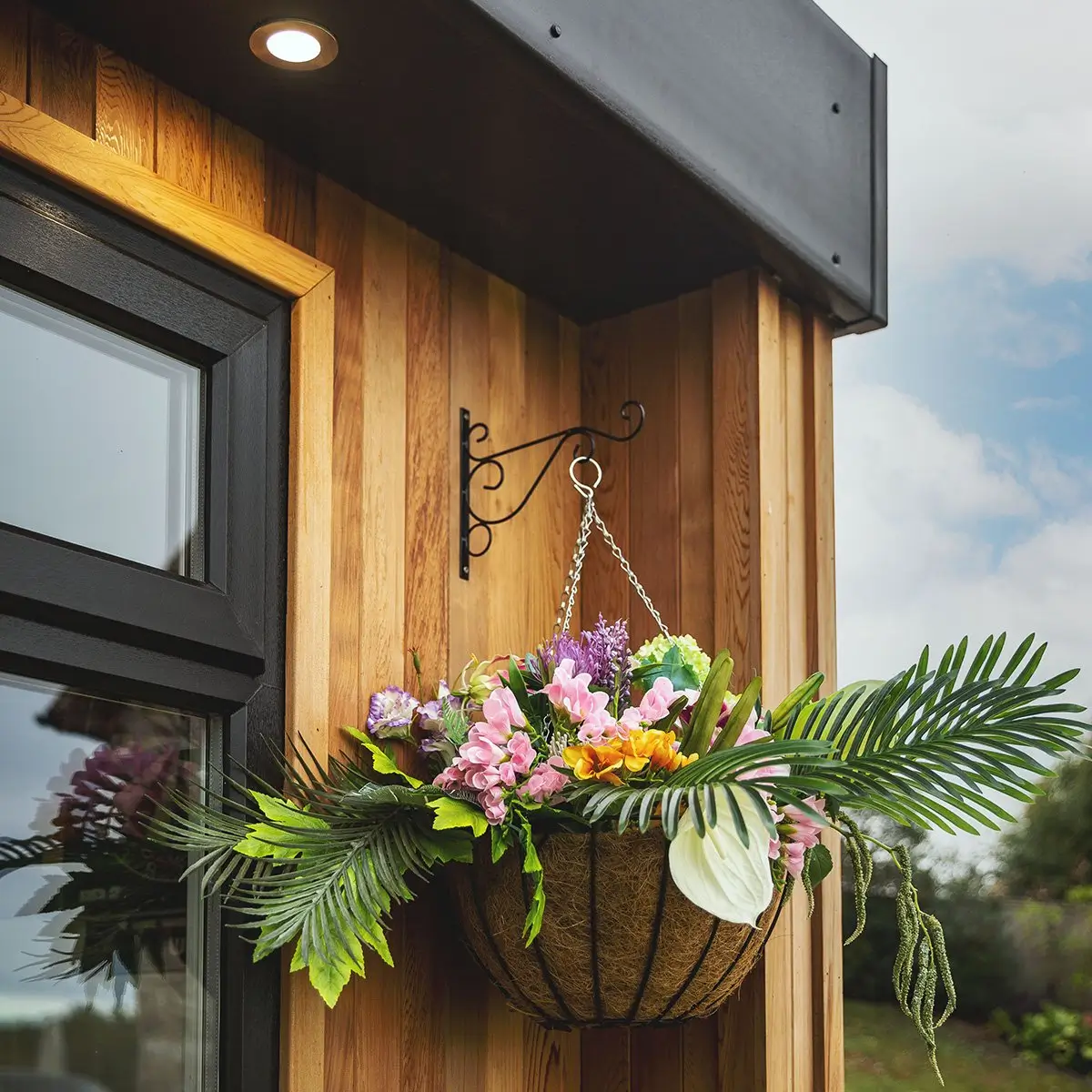 large cedar garden room with hanging basket 