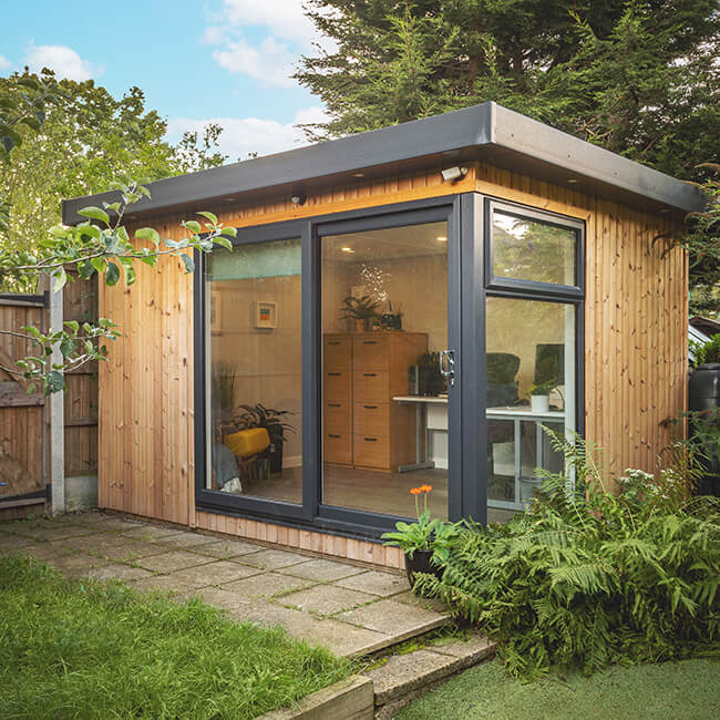 Cabin Master redwood garden room with sliding doors and large full length window