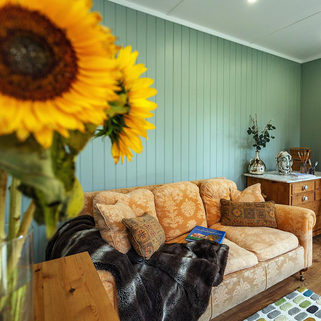 Interior of a garden room for hobbies with sunflowers in the foreground