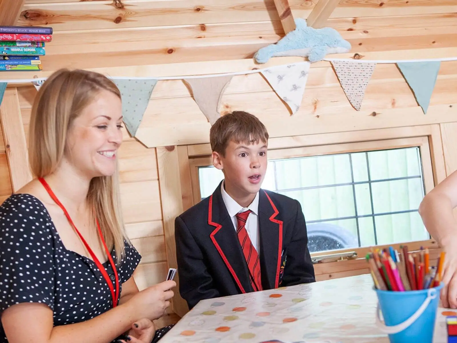 Cabins For Schools George Spencer building with student and teacher and bunting 