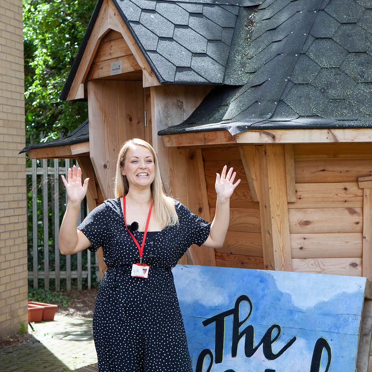Teacher excited to be outside her new unique, quirky school hut
