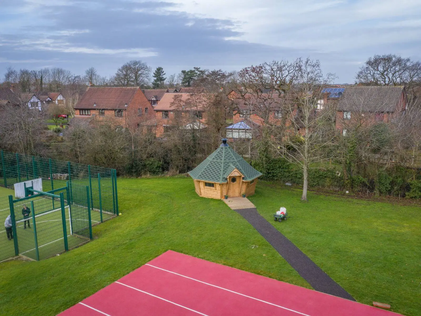 Cabins for Schools Springfield School Stills with green roof and grassy playground area and patio pathway and football pitch