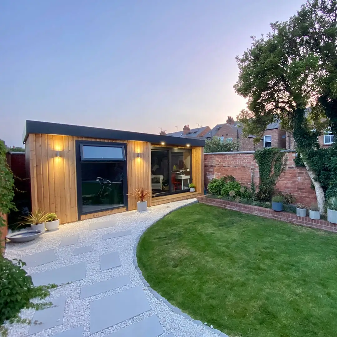 Early evening shot of a garden gym with external downlights 