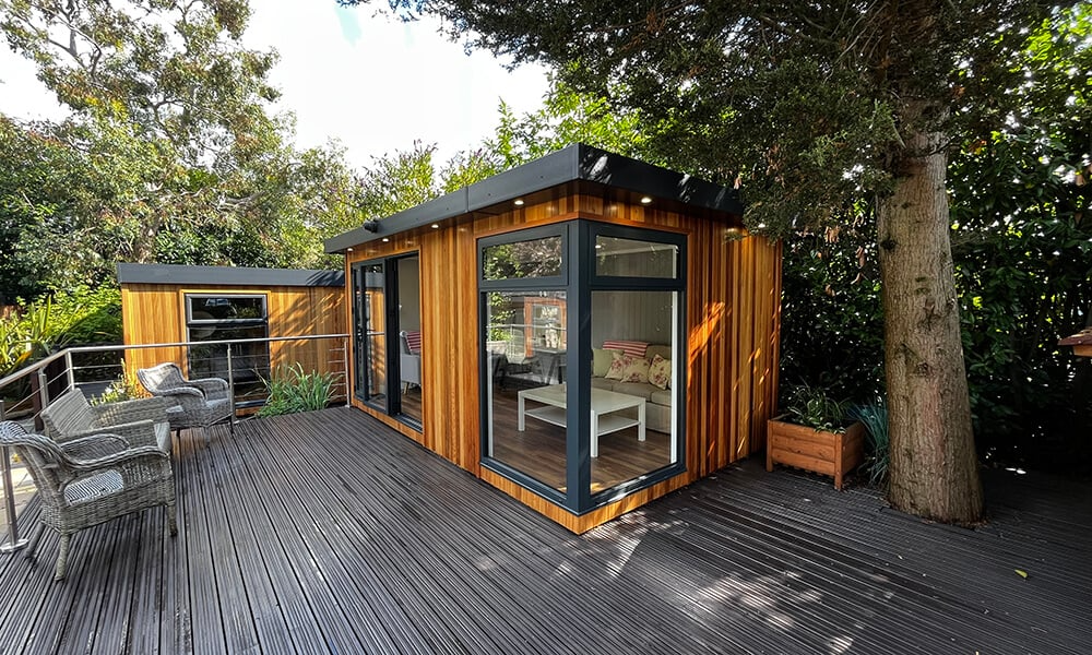Garden room on raised decking area and outdoor furniture