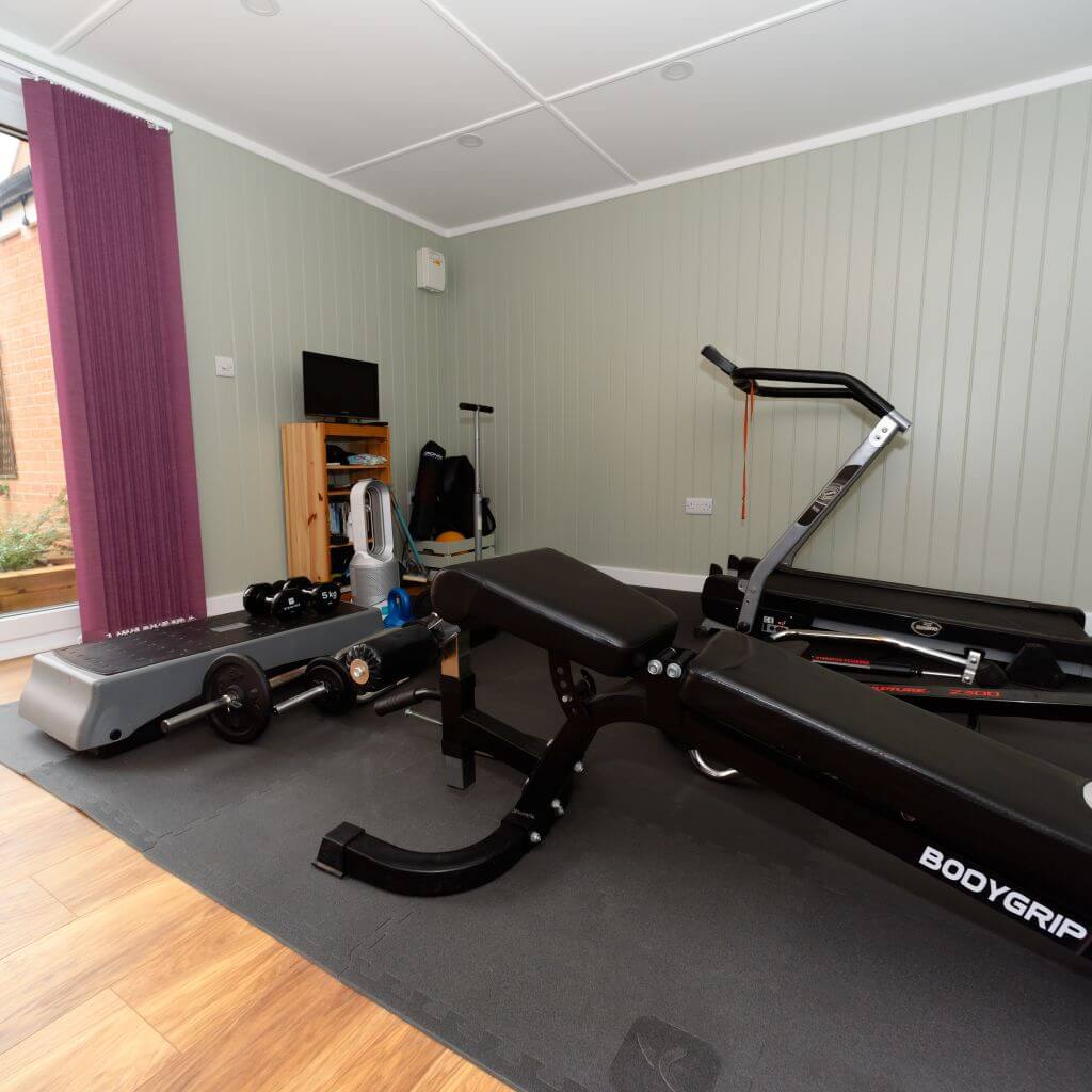 inside view of redwood garden rehabilitation room with gym equipment and mat area