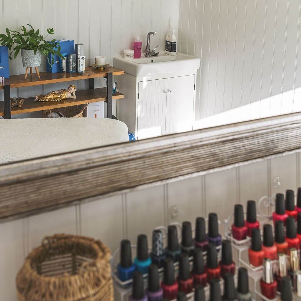 large mirror and row of nail polish with sink inside home business garden office 