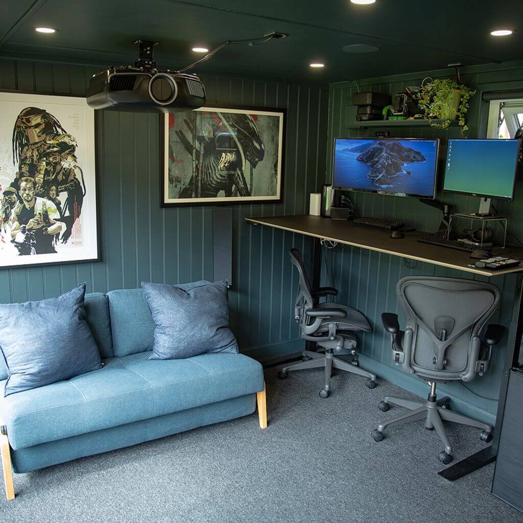 a garden cinema room with a blue couch and computer desk