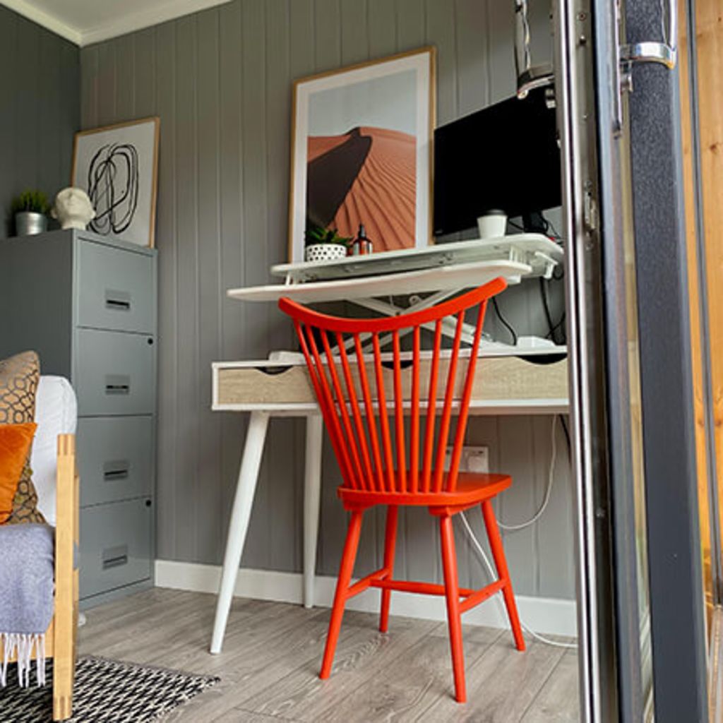 garden gym and small home office room with orange chair and desk with cabinet
