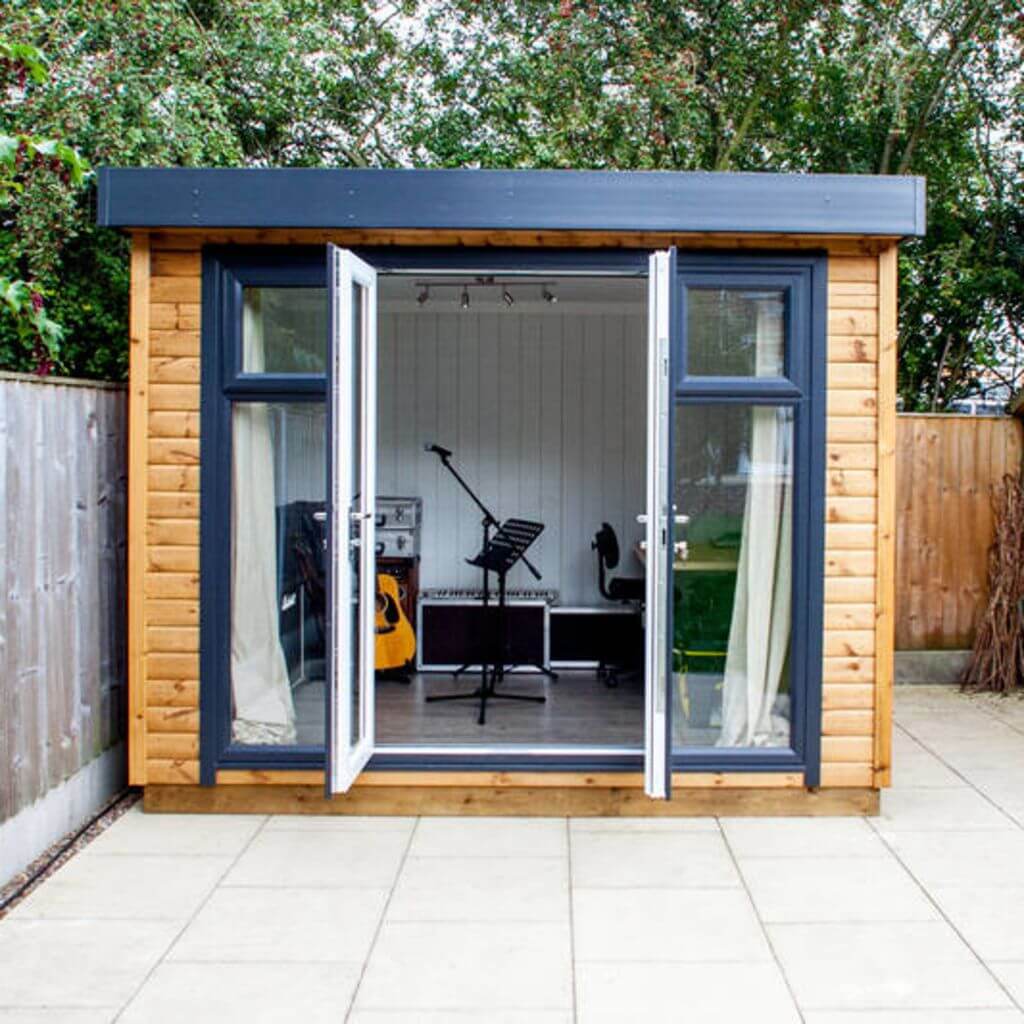 small garden music room with large open doors in patio area with guitar and microphone inside