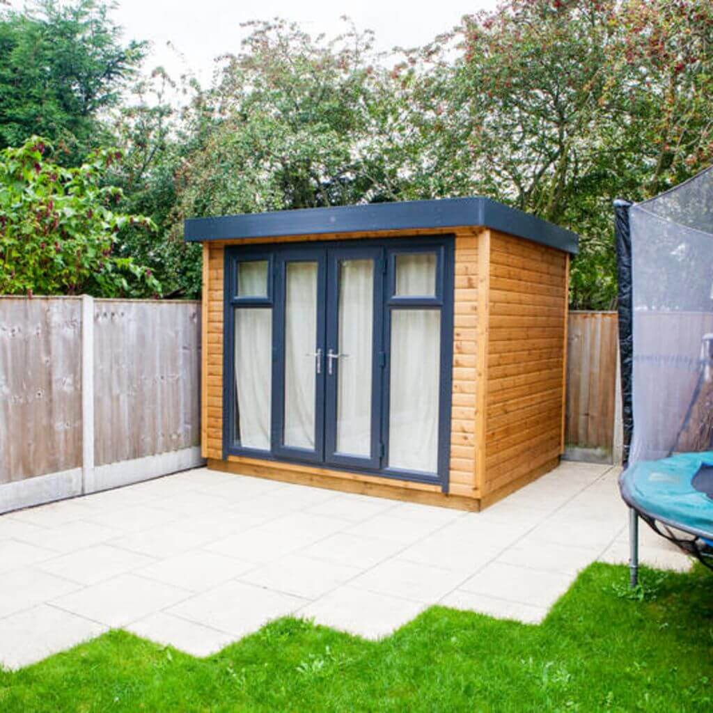 small garden music room with curtains closed on patio area with green lawn