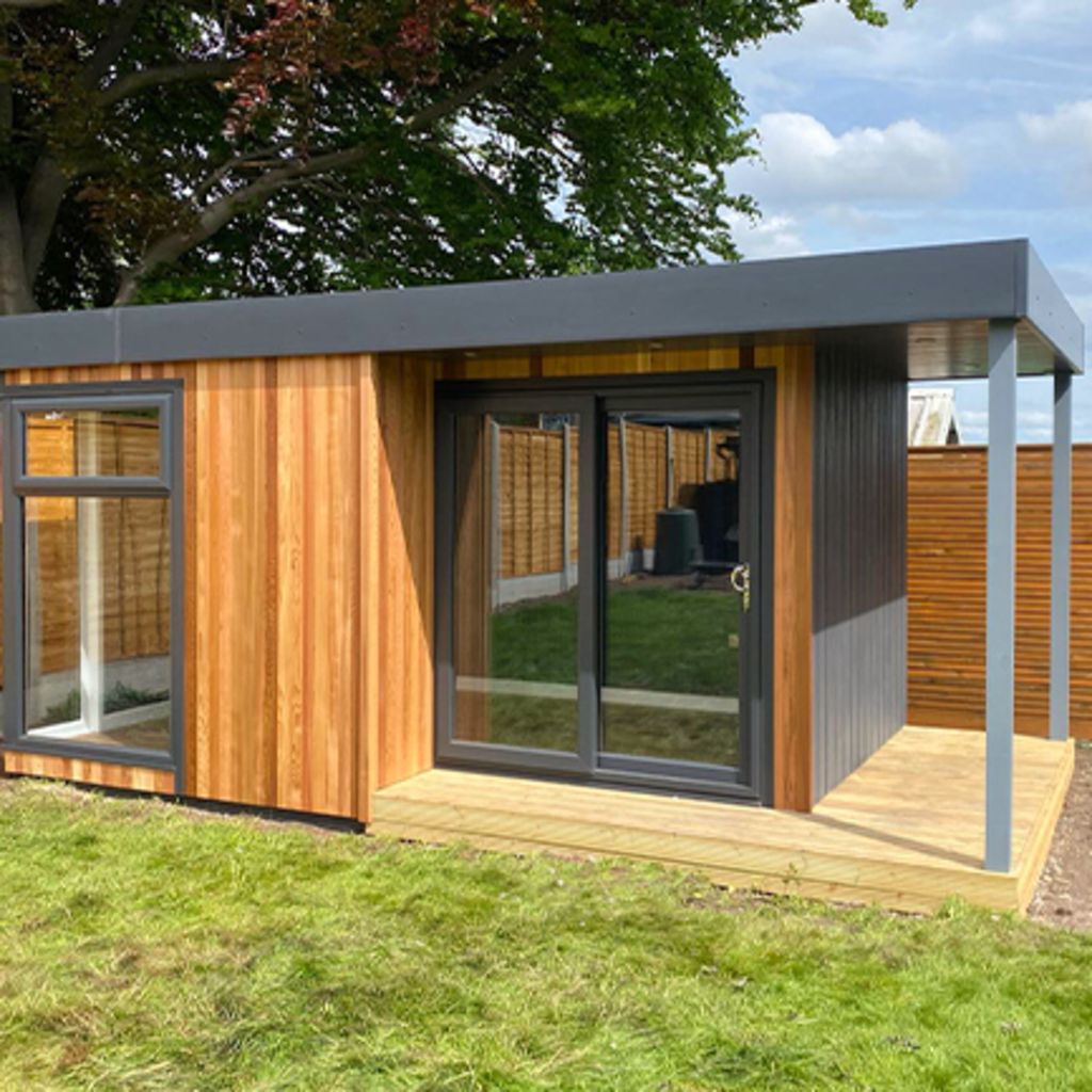 Cedar Garden Room with veranda in grassy lawn with large black doors and windows